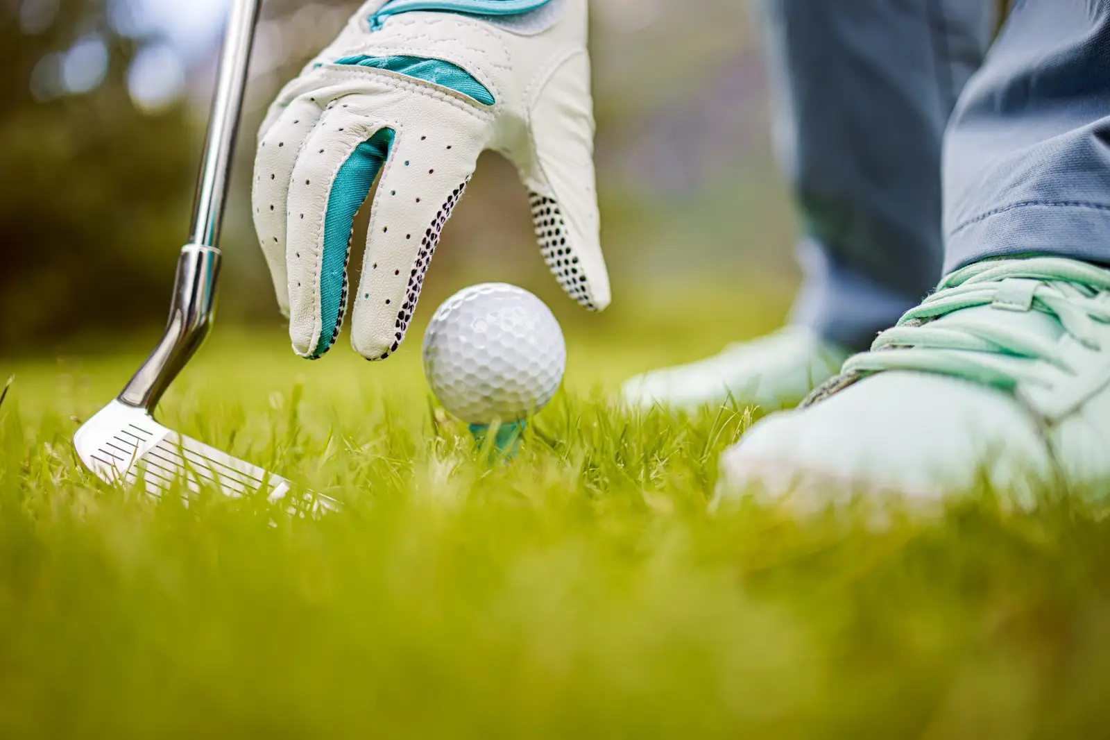 Golfball wird auf das Tee gelegt